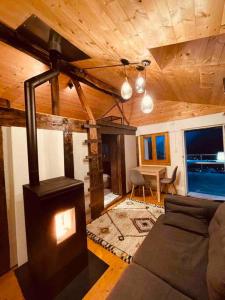 a living room with a wood stove in a house at Alpine Bliss - Cozy Chalet with Panoramic Views in Martigny-Combe