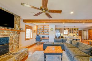 a living room with a couch and a fireplace at The Lodge on Smith Mountain Lake in Huddleston