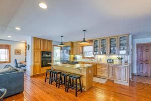 a large kitchen with wooden cabinets and bar stools at The Lodge on Smith Mountain Lake in Huddleston