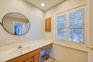 a bathroom with a sink and a mirror at The Lodge on Smith Mountain Lake in Huddleston
