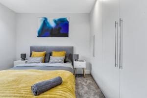 a bedroom with a bed and a yellow blanket at Private and Luxury Apartment in Central London in London