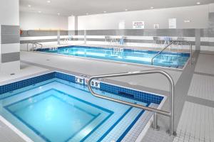 a large swimming pool with blue water at The Westin Calgary Airport in Calgary