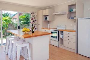 a kitchen with a counter with bananas on it at Cozy Cottage in Whitianga