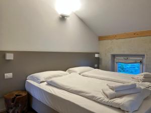A bed or beds in a room at Albola Suite Holiday Apartments