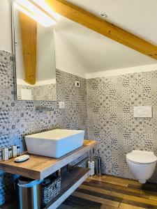 a bathroom with a white tub and a toilet at Albola Suite Holiday Apartments in Riva del Garda