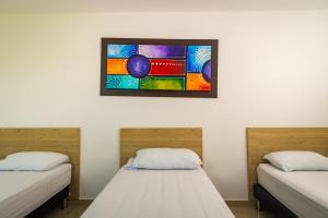Rúm í herbergi á Genesis Hotel