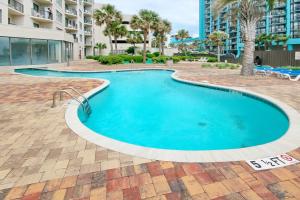 a large swimming pool in a courtyard with a building at The Palace Resort Unit 2310 in Myrtle Beach