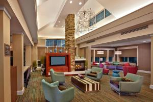 a lobby with a waiting area with couches and a fireplace at Residence Inn by Marriott Waldorf in Waldorf