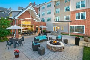 a patio with a fire pit and tables and chairs at Residence Inn by Marriott Waldorf in Waldorf
