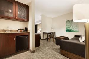 a living room with a couch and a table at Springhill Suites by Marriott West Palm Beach I-95 in West Palm Beach