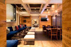 un restaurante con sofá azul, mesas y sillas en The Westin O'Hare en Rosemont