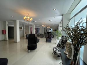 a lobby with couches and chairs in a building at Sunec Hotel in Chiclayo