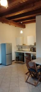 a kitchen with a table and a blue refrigerator at Ca' Greta - Big apartment close Estoril beach in Sal Rei