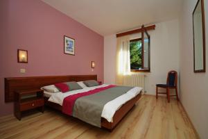 a bedroom with a bed and a window at Apartments with parking space Rabac, Labin - 3011 in Rabac