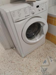 a white washing machine sitting in a bathroom at La tavernetta del Peo casa vacanze in Sanremo +11 photos