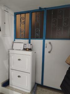 a room with a white dresser and a door at La tavernetta del Peo casa vacanze in Sanremo