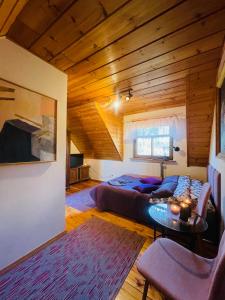 a bedroom with a bed and a table in a room at Siedlisko Zatoka in Augustów