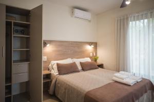 a bedroom with a large bed and a window at Altos del Champaqui in Villa Carlos Paz