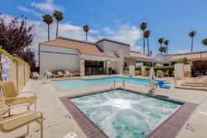 a swimming pool in a yard with a house at Best Western Plus Big America in Santa Maria