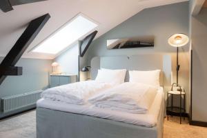 a bedroom with a large bed with a skylight at Scandic Oslo City in Oslo
