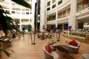 a lobby with couches and chairs in a building at Radisson Blu Hotel New Delhi Dwarka in New Delhi