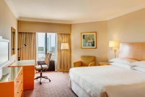 a hotel room with a bed and a desk and a television at Sheraton Buenos Aires Hotel & Convention Center in Buenos Aires