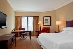 a hotel room with a bed and a desk and a computer at Sheraton Buenos Aires Hotel & Convention Center in Buenos Aires