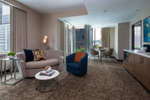 a living room with a couch and chairs in a hotel room at Courtyard New York Manhattan/Midtown West in New York