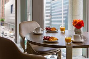 a table with breakfast foods on it in a room with a window at Courtyard New York Manhattan/Midtown West in New York