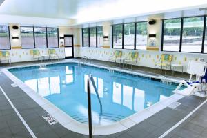 a large swimming pool with chairs in a building at Fairfield Inn & Suites by Marriott Omaha West in Omaha
