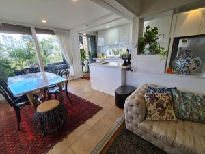 a kitchen and living room with a table and a couch at Vista unit Close to the City & Airport & Train station and Brighton Le Sands Beach in Sydney