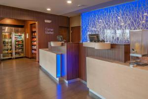 a store lobby with a check in counter and a pharmacy at Fairfield Inn & Suites by Marriott Dallas Plano North in Plano