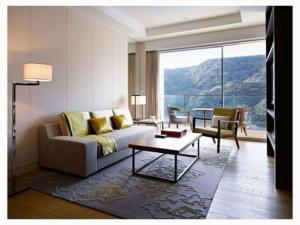 a living room with a couch and a table at OliveBay Hotel in Saikai