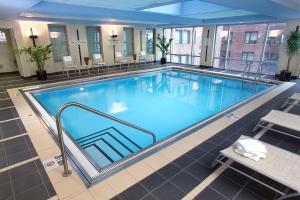 a large swimming pool with blue water in a building at Courtyard Chicago Downtown/Magnificent Mile in Chicago