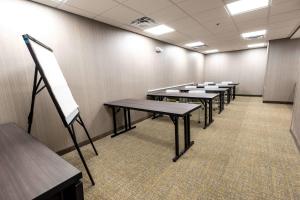 a classroom with rows of tables in a room at SpringHill Suites Columbus Airport Gahanna in Gahanna