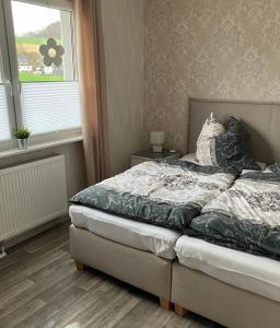 a bedroom with a bed and a window at Mellys Café & Store in Einbeck