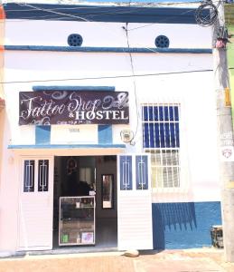 un edificio blanco con un cartel en la parte delantera en Squid Hostel, en Santa Marta