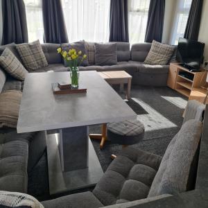 a living room with a couch and a table at Nicks & Carmels by the sea in Heysham