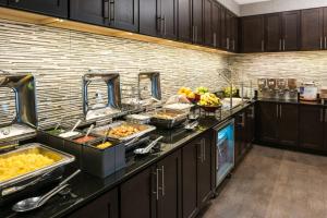 a kitchen with a bunch of food on a counter at Residence Inn by Marriott Boston Needham in Needham