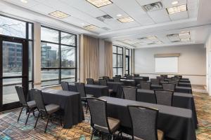 una sala de conferencias con mesas, sillas y una pizarra en Residence Inn Louisville Downtown, en Louisville