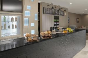 a bakery counter with bread and pastries on display at Courtyard by Marriott Austin Pflugerville in Pflugerville