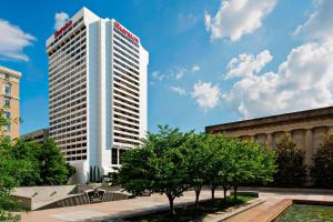a tall white building with a red sign on it at Sheraton Grand Nashville Downtown in Nashville
