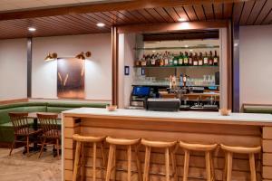 a bar with chairs and a counter with a bar at Fairfield Inn & Suites by Marriott Columbus, IN in Columbus