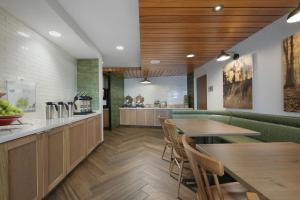 a restaurant with tables and chairs and a counter at Fairfield Inn & Suites by Marriott Pottstown Limerick in Pottstown