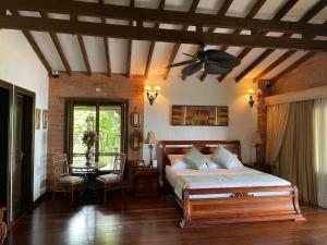 a bedroom with a bed and a ceiling fan at Finca hotel Villa Camila in Copacabana