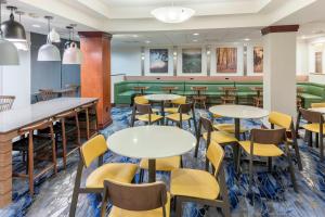 a dining room with tables and yellow chairs at Fairfield Inn & Suites by Marriott Austin Parmer Tech Ridge in Austin