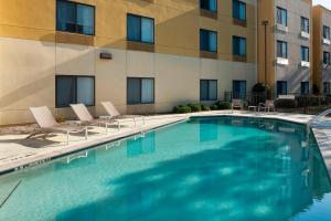 a swimming pool in front of a building at SpringHill Suites Columbus in Columbus