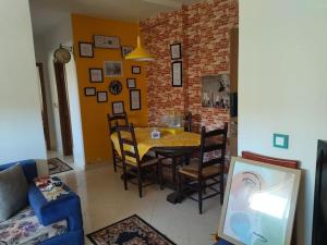 a dining room with a table and chairs and a brick wall at Apparemment in Oujda