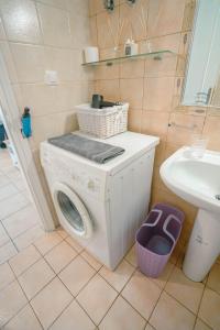 a washing machine in a bathroom with a sink at cozy couple retreat in Kalamata