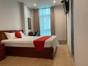 a bedroom with a bed and a window and a television at Sao Nam Hotel - Bui Vien Walking Street in Ho Chi Minh City
